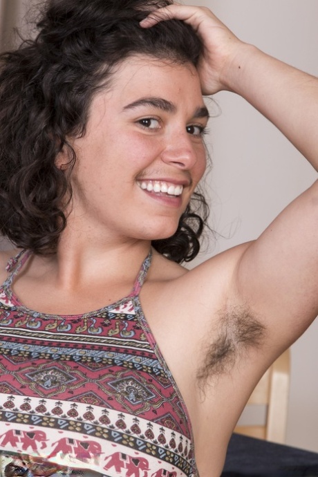 Dark haired babe with big tits Serai teasing her hairy vagina in a solo