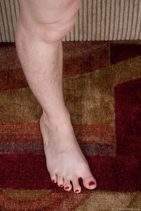 Luscious amateur redhead Zia showing off her hairy legs and shaggy snatch