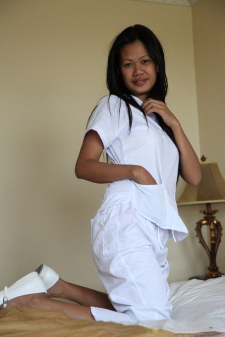 Sexy young filipina nurse Joanna doffs uniform pants to show her trimmed pussy