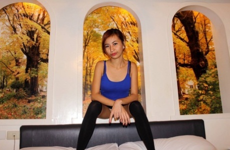 Slim Filipina girl shows off the pink of her shaved vagina after getting naked