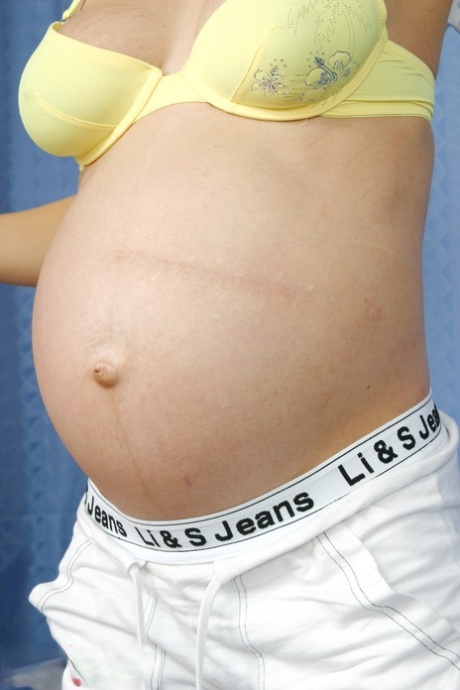 Pregnant cutie Michaela Krausova on her back toying her yummy snatch