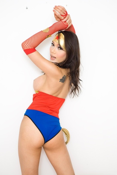 Shemale in Winder Woman cosplay costume Paula toys her pussy with giant dildo