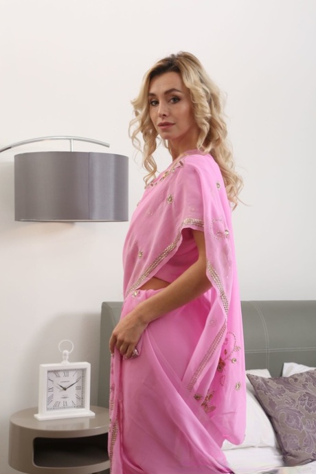 Blonde Dominika strips her pink outfit and poses nude in hot stockings