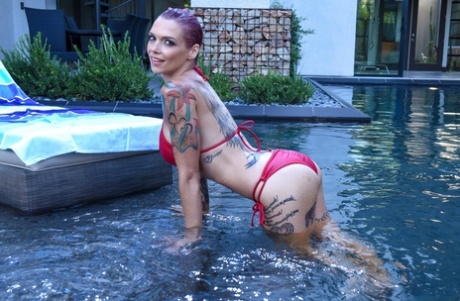 Tattooed solo female Anna Bell Peaks models soaking wet in a bikini