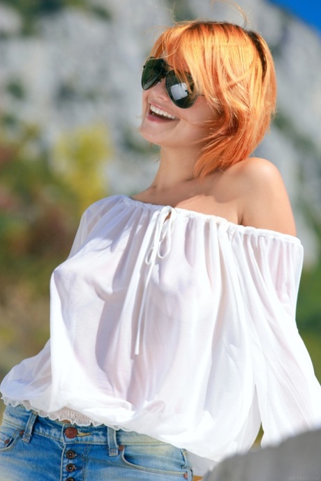 Beutiful redheaded babe Violla A shows off her yummy pussy all nude outdoors