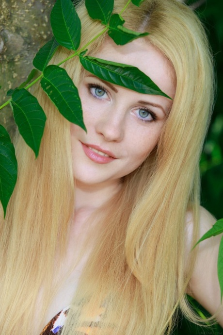Blue eyed beauty Fay Love shows her big ass and poses naked in the woods
