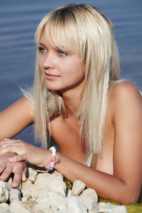 Beautiful blue eyed teen Lada shows off her tight love holes on the beach