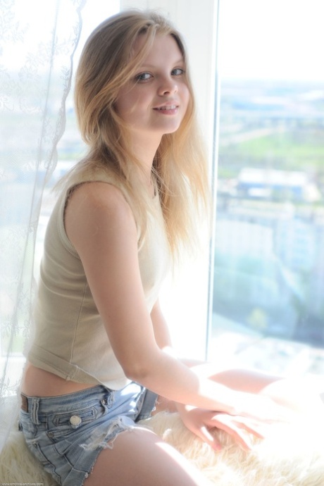 Lovely blonde teen Kisa shows off her big booty & her shaved pussy