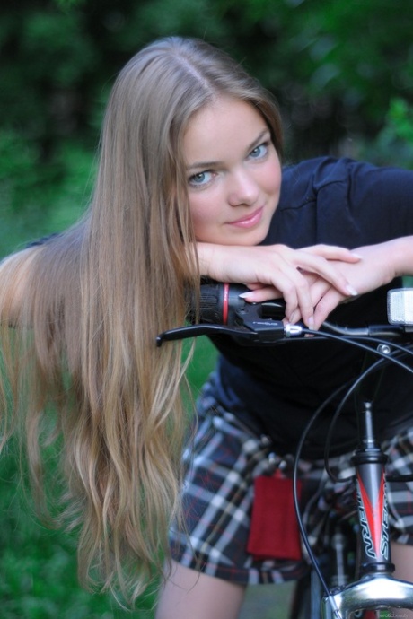 Gorgeous teen babe Bridgit A riding her bicycle pantyless in nature