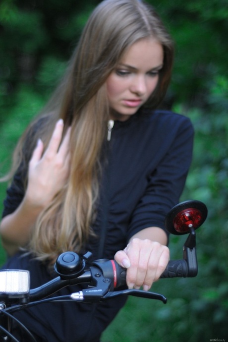 Gorgeous teen babe Bridgit A riding her bicycle pantyless in nature