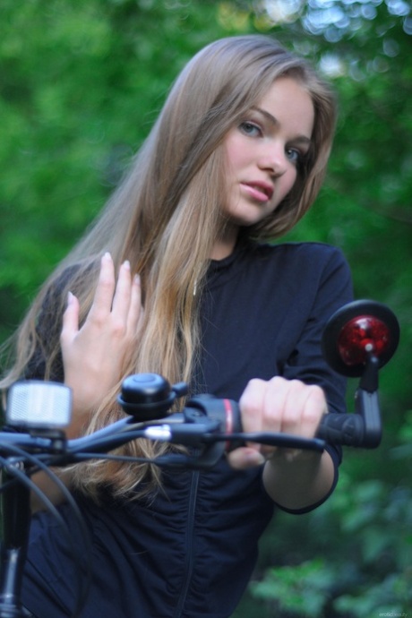 Gorgeous teen babe Bridgit A riding her bicycle pantyless in nature