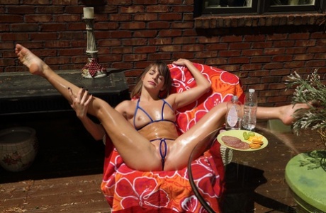 Beautiful amateur teen Kimmy Granger toying her oily pussy on a patio chair