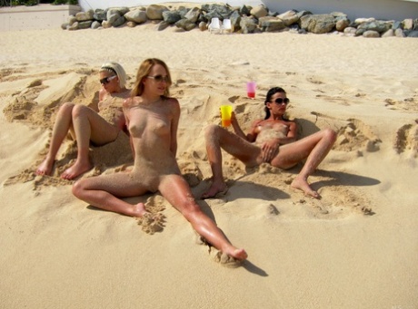 Blonde lesbian Bibi Noel & her slutty GFs fool around while naked at the beach