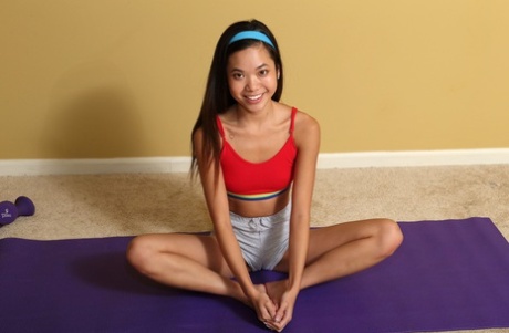 Petite Asian girl Vina Skyy stretches & strips before toying herself on a mat