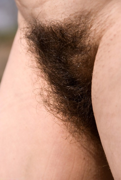 Naughty MILF Sandra K strips fully naked  shows off her hairy pussy outdoors