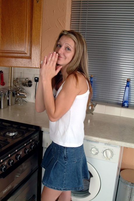 Petite teen Kim B spreading her meaty pussy in a hot kitchen striptease