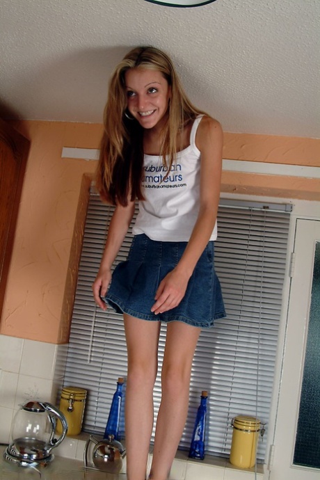 Petite teen Kim B spreading her meaty pussy in a hot kitchen striptease