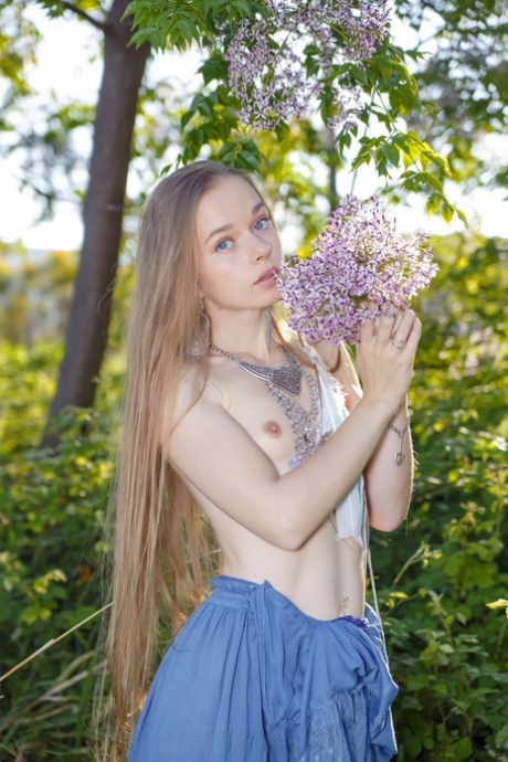 Tiny boobed babe Milena Angel strips her long dress & rubs her pussy in nature