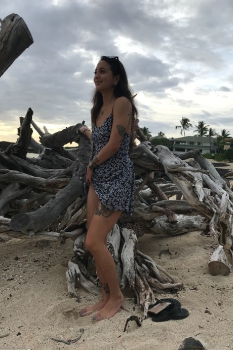 Teen Mi Ha Doan flashes her tits and exposes her hairy pussy on the beach