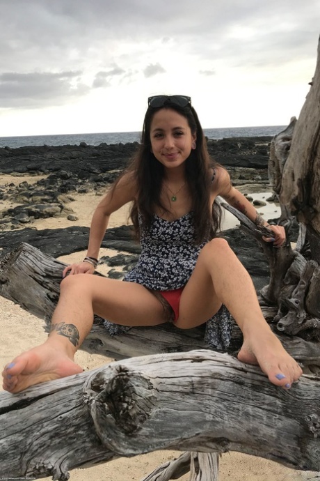 Teen Mi Ha Doan flashes her tits and exposes her hairy pussy on the beach