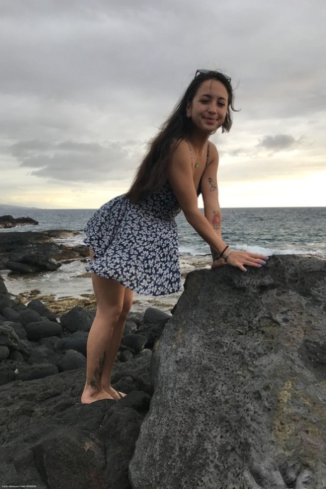Teen Mi Ha Doan flashes her tits and exposes her hairy pussy on the beach