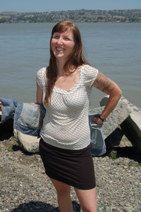 Smiley cutie Natalie strips on the beach and sunbathes her body & furry pussy