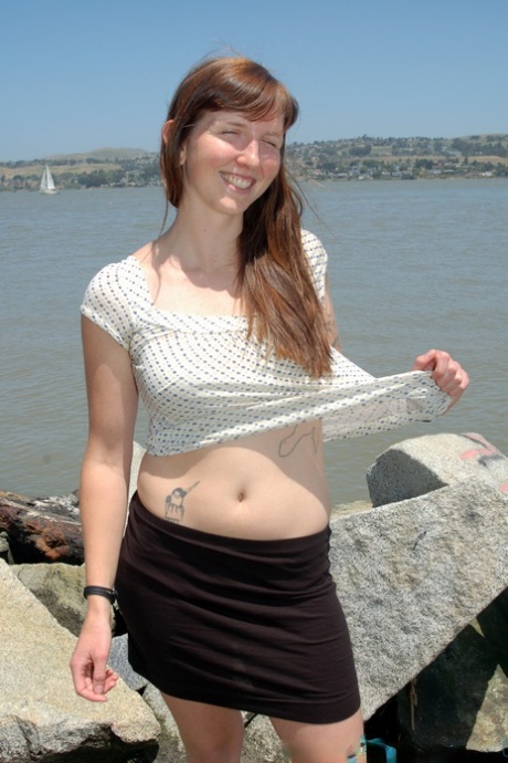 Smiley cutie Natalie strips on the beach and sunbathes her body & furry pussy