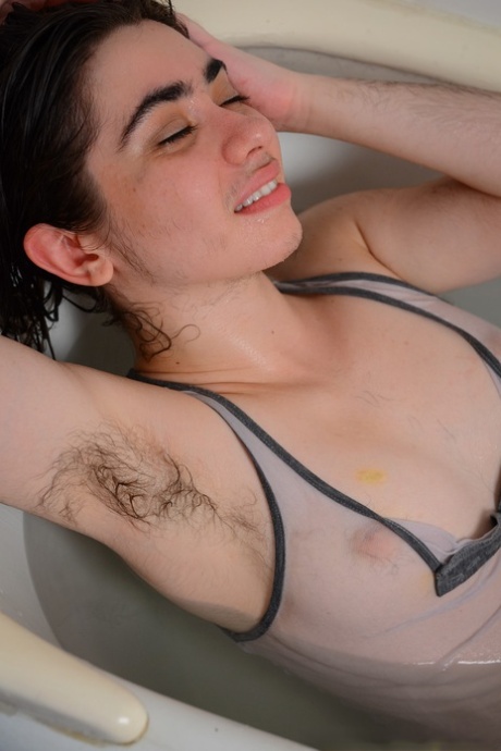 Hairy seductress Kisa Fae strips in the bathtub and washes herself