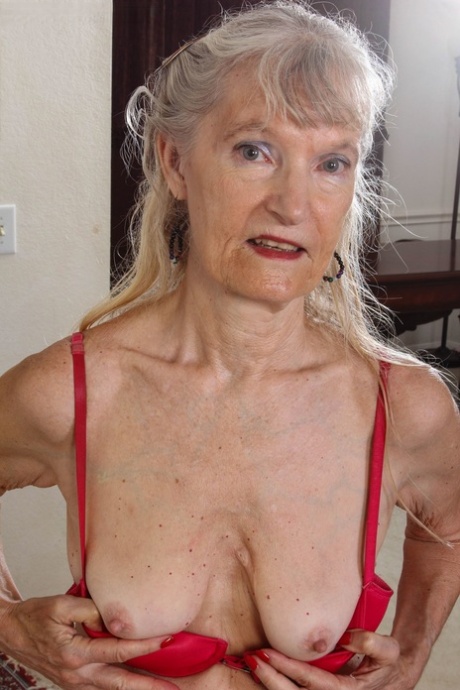 Old granny Lisa Cognee exposes her tiny titties and rubs her pussy in a solo