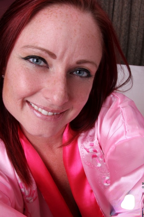 Redheaded mom Sandi Lymm unveils her huge curves and masturbates