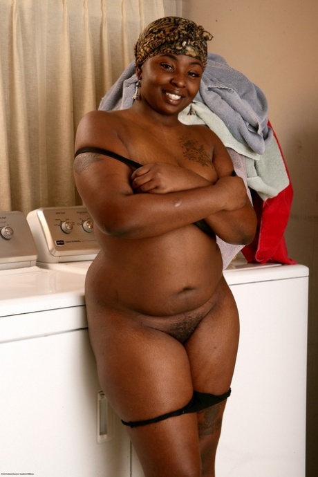 Chubby ebony Chocolate unveils her big tits & ass & rubs her hairy twat