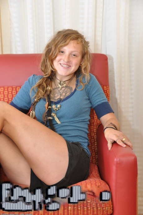 Teen hippie with tattoos Naomi shows her bushy beaver and poses in a solo