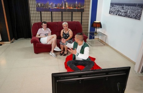 Horny granny Sara One enjoys a young cock on the sofa & takes a facial