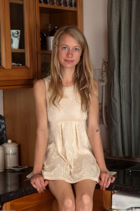 Amateur teen Selena reveals her bushy twat and small tits in the kitchen