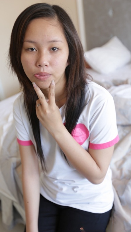Petite Asian girl Yum gives a handjob before taking a dick in her pussy