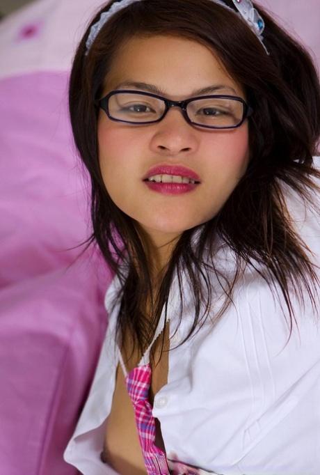 Pretty Thai schoolgirl Dar poses in her hot outfit and strips her panties off