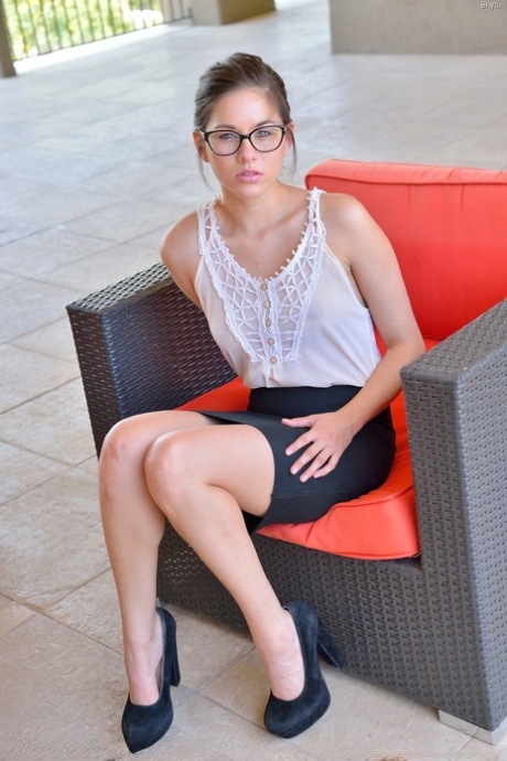 Skinny teen in glasses Shyla fists her shaved clam on an outdoor bench