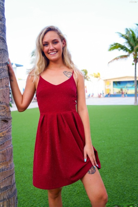 Cute blonde Winter hikes her red dress up and touches her cunt in public