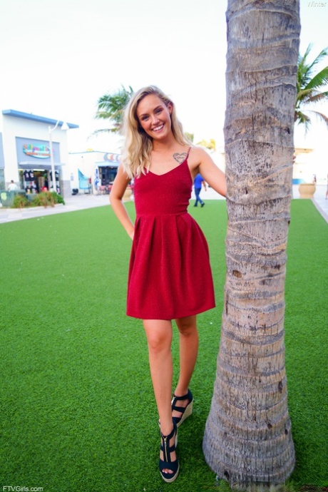 Cute blonde Winter hikes her red dress up and touches her cunt in public