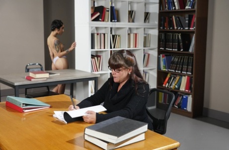 Petite inked librarian Avery Black exposes her ass and gets fucked at work