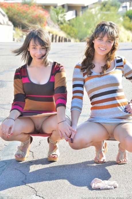 Sweet teens Athena & Mindy flash their asses outdoors before indoor fingering